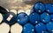 Old chemical barrels. Blue and red oil drum. Steel and plastic oil tank. Toxic waste warehouse. Hazard chemical barrel with