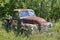 Old Cheverolet pickup truck sitting in a field