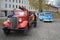 The old Chevrolet fire truck and the minibus Volkswagen T1 on the open exhibition of a retro transport