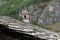 An old  chimney  and a roof, covered with stone slabs- typical  construction of houses in Tessin