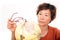 An old Chinese lady carefully looking at the globe in front of a white background