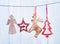 Old Christmas decorations hanging on string on blue background