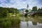 Old church and bridge mirroring in river, Bohinj lake, Slovenia