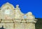 Old church facade details and blue sky in Tellaro Liguria, Italy