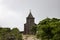 Old church in green trees landscape. Historical building on Bokor Hill. Abandoned church in forest