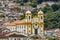 Old church between the houses and streets of the city of Ouro preto in Minas Gerais