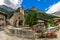 Old church and mountains in small alpine village of Chianale, Italy