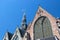 Old Church Oude Kerk the oldest building in De Wallen Amsterdam, Netherlands against blue sky.