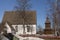 Old church and wooden belfry against blue sky