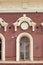 Old city, Prettily suburban town. Architectural details and decoration of the vintage stucco facade framing the windows - console