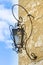 Old city wall lantern on yellow wall and blue sky