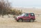 Old classic 4WD car Suzuki Vitara driving on a beach