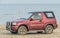 Old classic 4WD car Suzuki Vitara parked on a beach