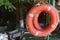 Old classic lifebuoys hang on the beach against the blurred background of the recreation center