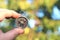 Old classic navigation compass in hand on natural background