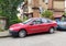 Old classic red Renault Laguna first version left side view