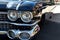 An old classic vintage retro automobile with big headlamps, front grill,  and lights