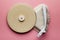 Old classic vinyl record player on pink pastel background