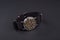 Old classic wristwatch for man on black background