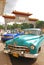 Old classic yank tank Cuban car parked in front of Havana China town Chinatown entrance, Cuba