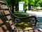 old classical cast iron and wood bench with bus shelter in park setting