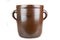 Old clay pot for storing food. Kitchen accessories on a white table