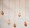 On an old clay wall hang vases on ropes, like decor