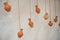 On an old clay wall hang vases on ropes, like decor