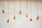 On an old clay wall hang vases on ropes, like decor