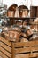 Old cleaned copper utensils piled in a wooden box in a store.