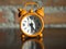 Old clock orange on the wooden table,