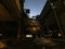 Old closed industrial ironworks at night. Epic metal structures and chimneys lit by the moon