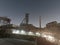 Old closed industrial ironworks at night. Epic metal structures and chimneys lit by the moon