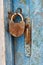 Old closed padlock rusty on wooden weathered door