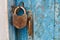 Old closed padlock rusty on wooden weathered door