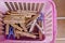 Old clothespin in pink basket