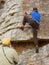 Old coach looks at rock climber