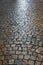 Old cobble stone road surface night light reflections background