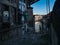 Old cobbled back street in Porto, Portugal with traditional buildings.