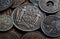 Old coins of different countries on a wooden table. Concept on history, numismatics, collecting, etc. Macro shot of ancient coins