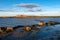 Old collapsing barn on the stone shore