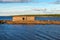 Old collapsing barn on the stone shore of the White Sea