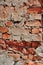 Old collapsing brick wall close up