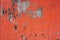 Old colored cracked wall. Grunge red wall texture for design. Colored cracked background