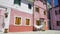 Old colored residential houses on Burano island, hot summer day in Italy, Venice