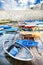 Old colored wooden boats in the small harbor. The Angevin castle in Gallipoli