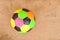 Old colorful football on cement floor