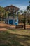 Old colorful gazebo and lighting pole in the middle of garden with green lawn, in a sunny day at SÃ£o Manuel.