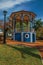 Old colorful gazebo and lighting pole in the middle of verdant garden, in a sunny day at SÃ£o Manuel.