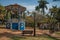 Old colorful gazebo and people amid garden full of trees, in a sunny day at SÃ£o Manuel.